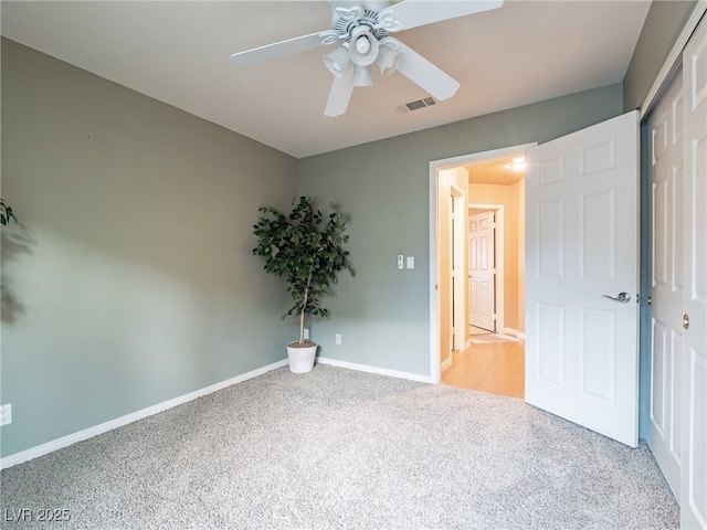 unfurnished bedroom featuring ceiling fan, a closet, and carpet flooring