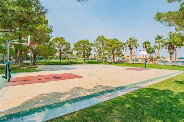 view of sport court with a lawn