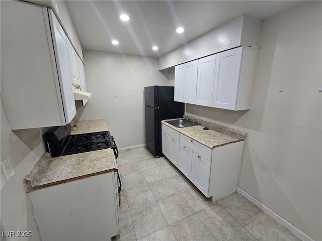 kitchen with black appliances, white cabinets, sink, and light tile patterned flooring