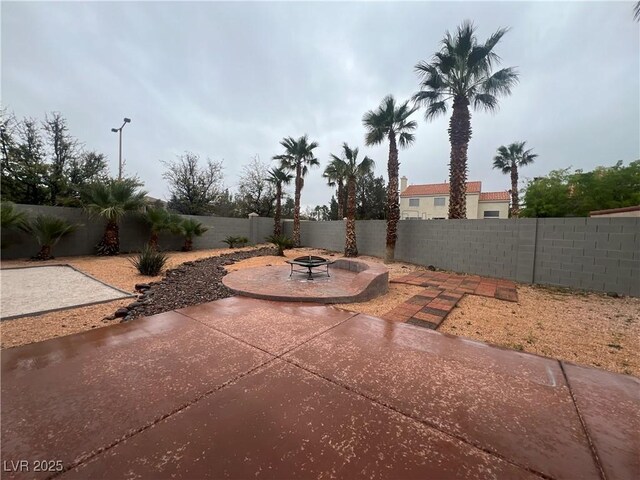 view of patio with a fire pit