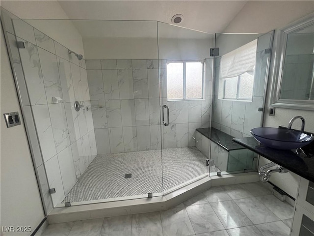 bathroom with vaulted ceiling, a shower with shower door, and sink