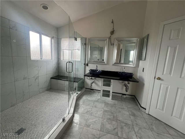 bathroom with sink and a shower with door