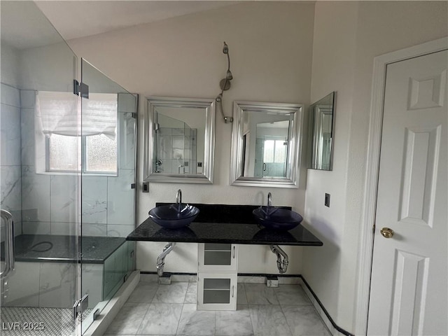 bathroom with walk in shower, a healthy amount of sunlight, and vanity