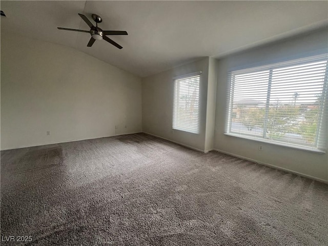 spare room featuring vaulted ceiling, ceiling fan, and carpet floors