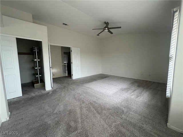 unfurnished bedroom featuring ceiling fan, a closet, and dark carpet