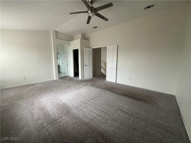 unfurnished bedroom featuring ceiling fan, carpet floors, and vaulted ceiling