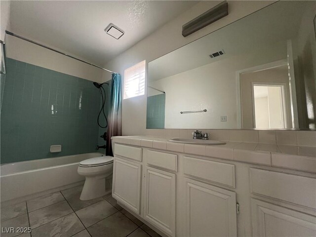 full bathroom featuring toilet, tile patterned floors, vanity, and shower / tub combo with curtain