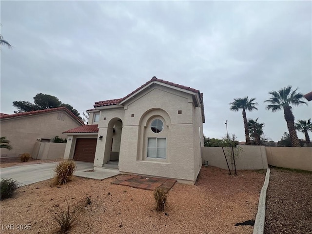 mediterranean / spanish house featuring a garage