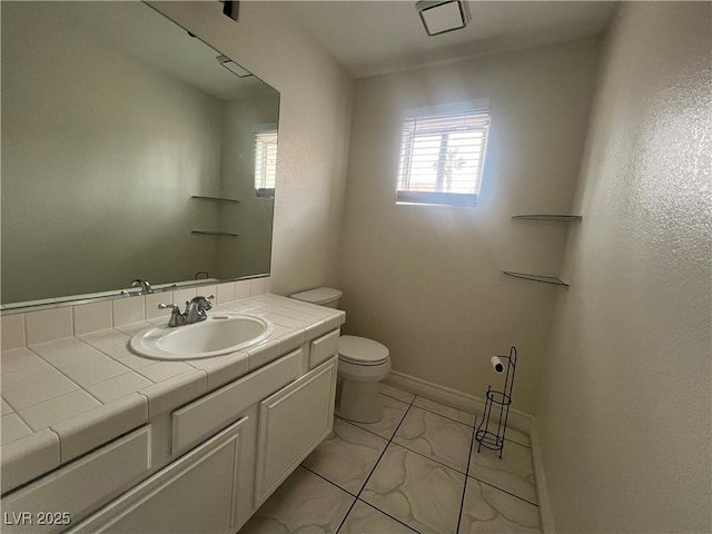 bathroom with toilet and vanity