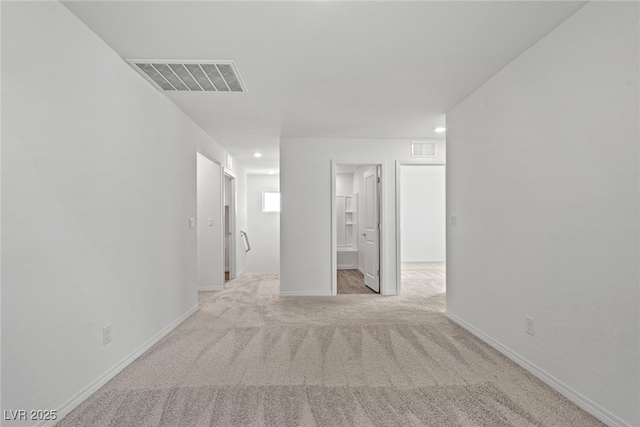 empty room featuring light colored carpet