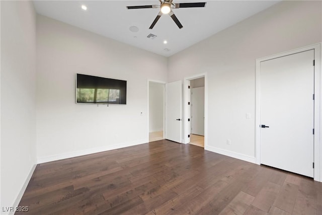 unfurnished bedroom with ceiling fan and dark hardwood / wood-style flooring