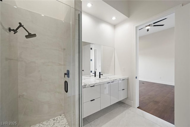 bathroom with ceiling fan, vanity, and a shower with door