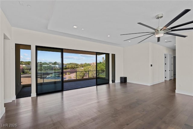 spare room with ceiling fan and dark hardwood / wood-style floors