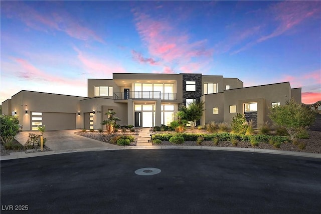 modern home featuring a garage and a balcony