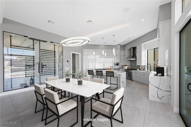 dining room with a notable chandelier and sink