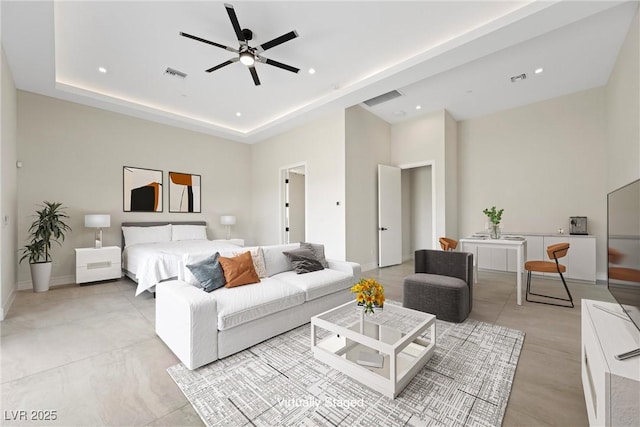 bedroom featuring ceiling fan and a raised ceiling