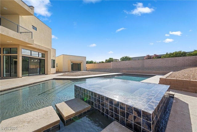 view of swimming pool with an in ground hot tub