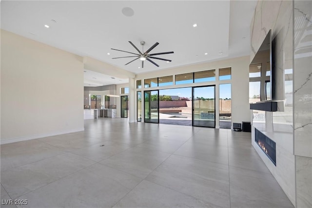 unfurnished living room featuring ceiling fan