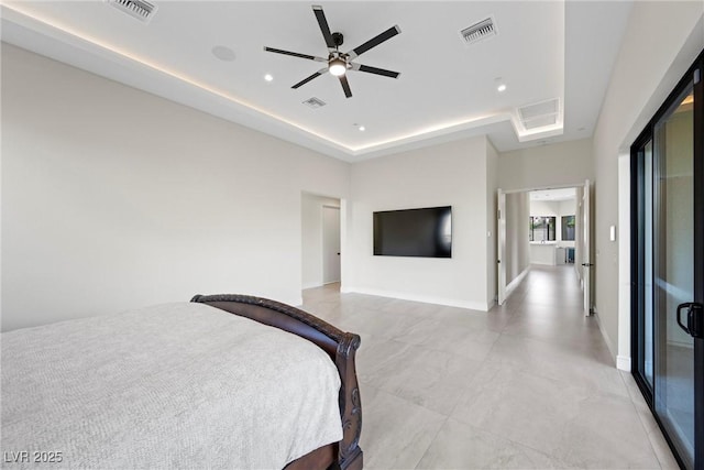 bedroom featuring ceiling fan and a tray ceiling