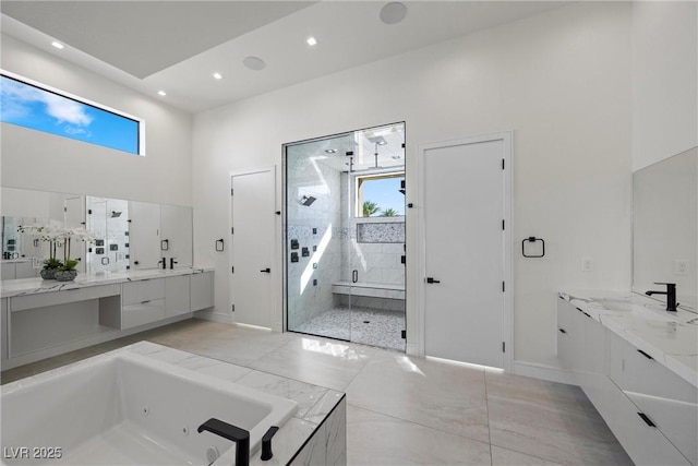 bathroom with independent shower and bath and vanity