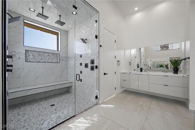 bathroom featuring walk in shower and vanity