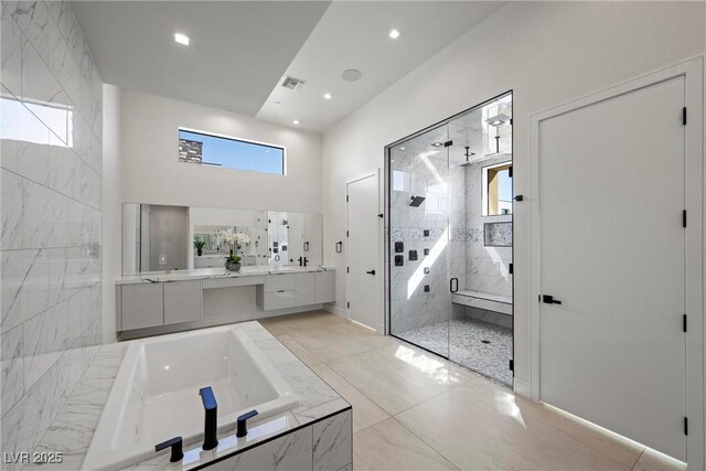 bathroom featuring vanity and shower with separate bathtub