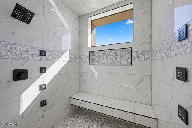 bathroom with a tile shower