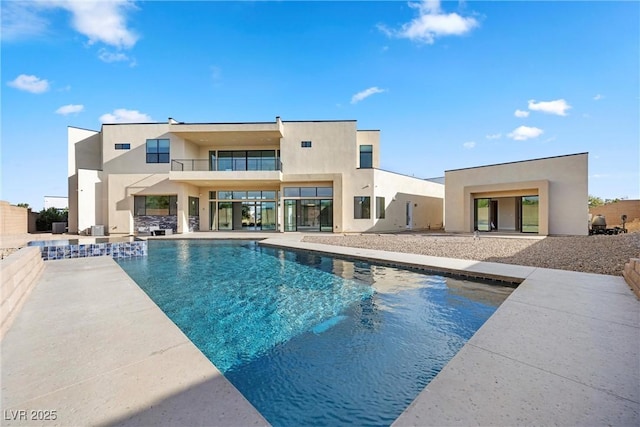 rear view of property featuring a balcony