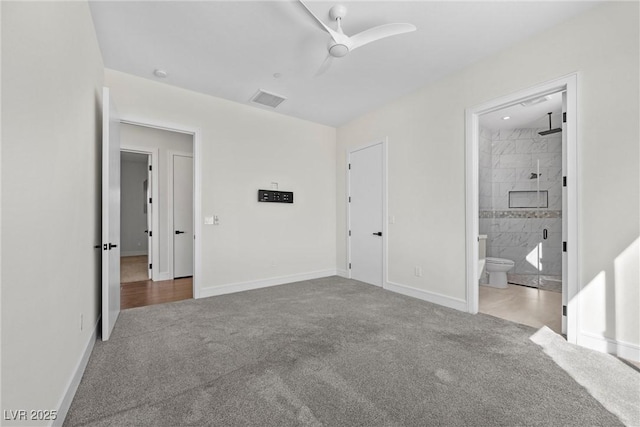 unfurnished bedroom with ceiling fan, carpet, and connected bathroom