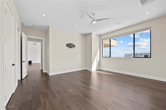 empty room featuring ceiling fan and dark hardwood / wood-style flooring