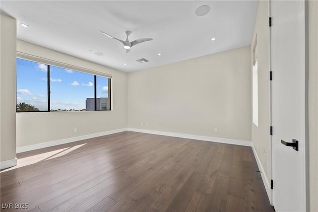 spare room with ceiling fan and wood-type flooring