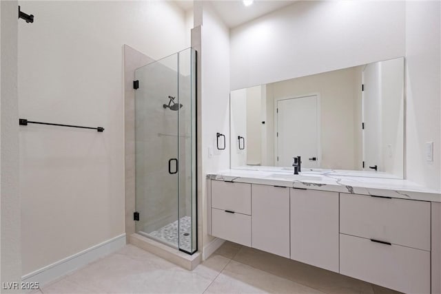 bathroom featuring an enclosed shower, vanity, and tile patterned flooring