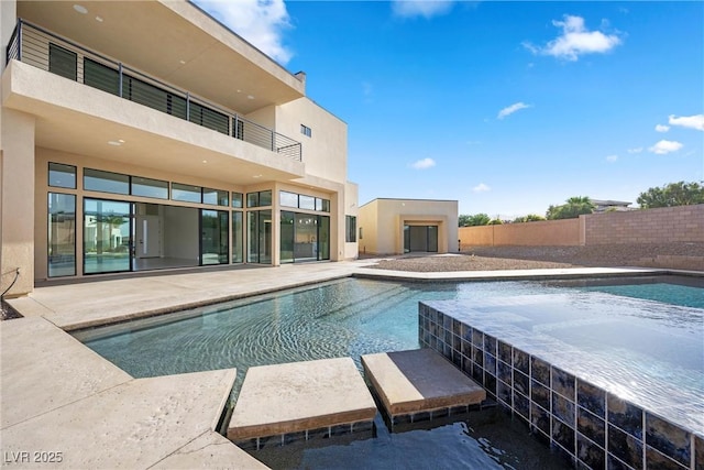 view of swimming pool with an outdoor fireplace and a patio