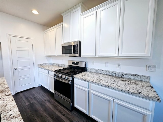 846 Star Estates Ave, North Las Vegas, NV 89086 - kitchen featuring stainless steel appliances, dark wood-type flooring, white cabinets, recessed lighting, and light stone countertops