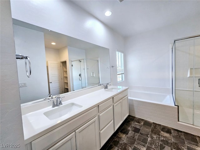 846 Star Estates Ave, North Las Vegas, NV 89086 - bathroom with a stall shower, a walk in closet, a bath, double vanity, and recessed lighting