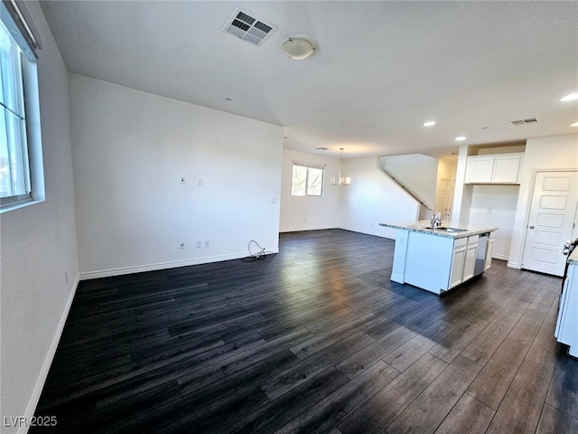 846 Star Estates Ave, North Las Vegas, NV 89086 - kitchen with a sink, dark wood-style floors, open floor plan, light stone countertops, and baseboards