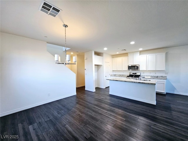 846 Star Estates Ave, North Las Vegas, NV 89086 - kitchen with stainless steel microwave, stove, baseboards, dark wood-style floors, and recessed lighting