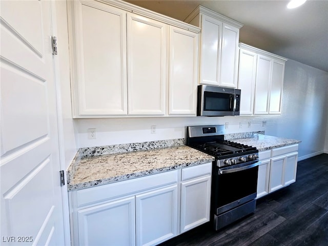 846 Star Estates Ave, North Las Vegas, NV 89086 - kitchen featuring stainless steel appliances, dark wood-style flooring, white cabinetry, and light stone counters