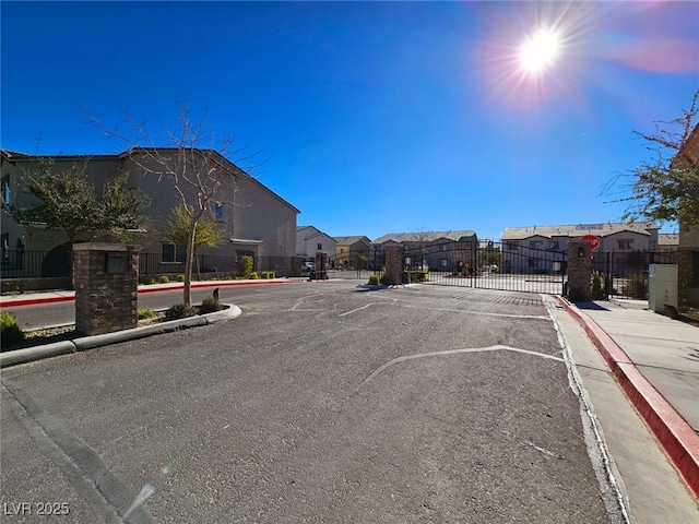 846 Star Estates Ave, North Las Vegas, NV 89086 - view of asphalt road featuring a residential view, curbs, a gate, sidewalks, and a gated entry
