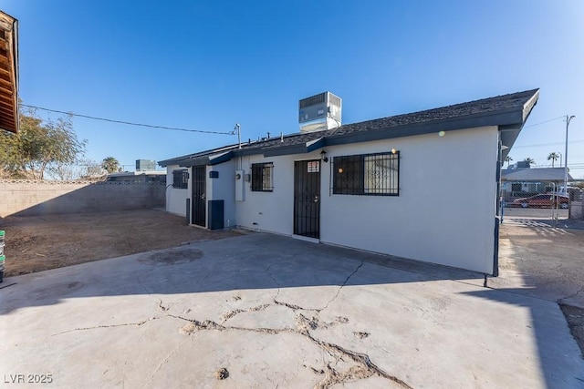 back of property featuring central AC unit and a patio area