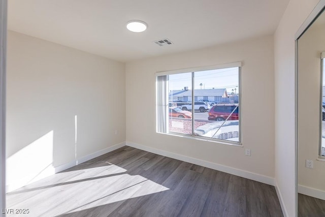 unfurnished room featuring hardwood / wood-style flooring