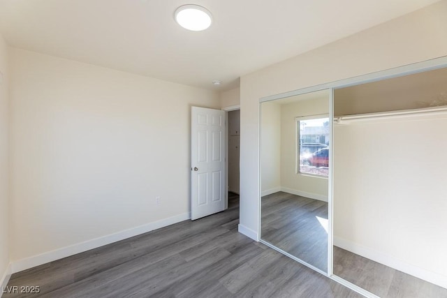 unfurnished bedroom featuring a closet and wood-type flooring