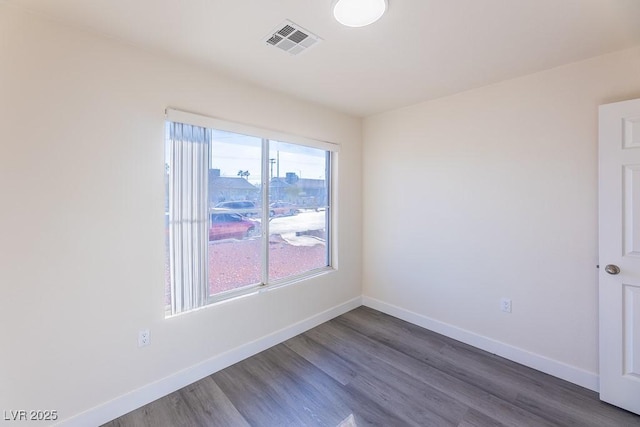 unfurnished room featuring dark wood-type flooring