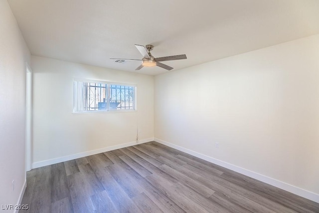 empty room featuring ceiling fan and hardwood / wood-style flooring