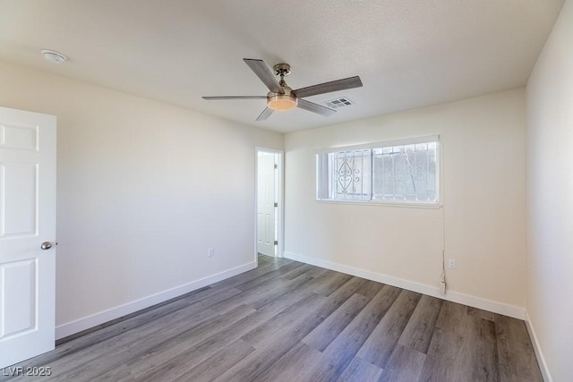 empty room featuring light hardwood / wood-style floors, a textured ceiling, and ceiling fan