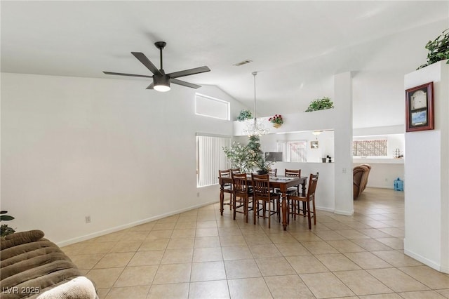 dining room featuring ceiling fan, vaulted ceiling, and light tile patterned flooring