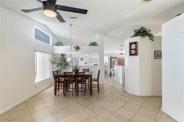 tiled dining room featuring ceiling fan and vaulted ceiling