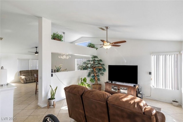 tiled living room with ceiling fan, plenty of natural light, and vaulted ceiling