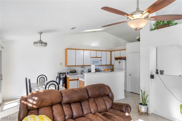 living room with ceiling fan, light tile patterned floors, and vaulted ceiling