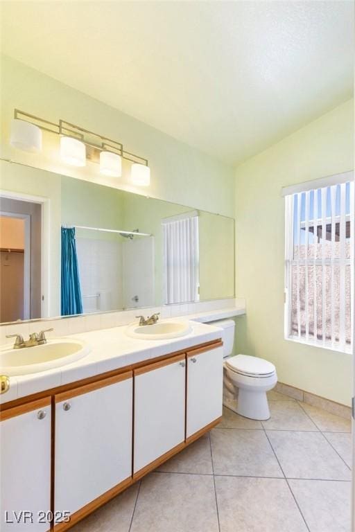 bathroom with toilet, tile patterned floors, vaulted ceiling, vanity, and curtained shower